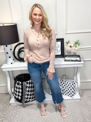 Beige top with ruffle details and button neckline