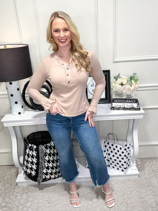 Beige top with ruffle details and button neckline