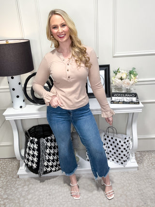 Beige top with ruffle details and button neckline