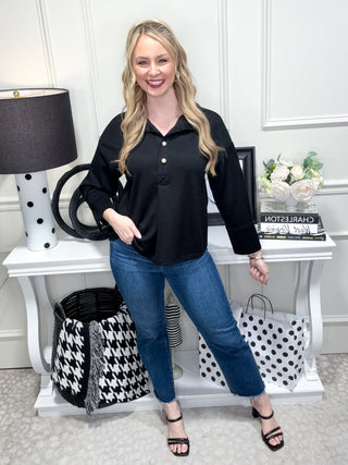 Black long sleeve top with pearl buttons