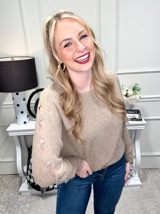 Cozy tan knit sweater with button sleeves