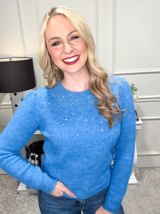 blue knit sweater with rhinestone details