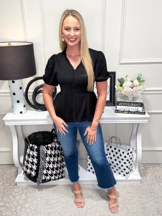 Black top with ruffle neckline and trim
